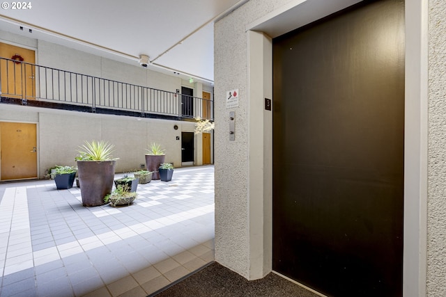 interior space with elevator and tile patterned floors