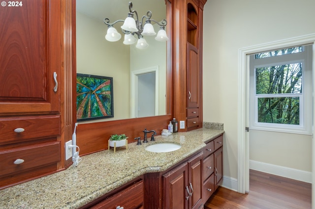 bathroom with hardwood / wood-style flooring, vanity, and a notable chandelier