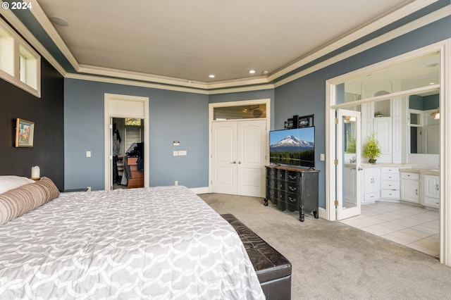 bedroom featuring light carpet, ensuite bathroom, and crown molding