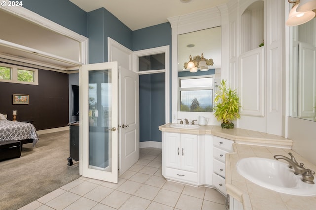 bathroom featuring large vanity, tile floors, and a bath to relax in