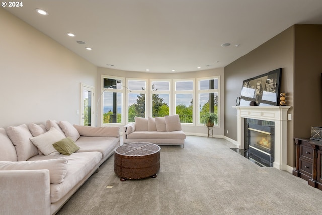 living room with carpet and a fireplace