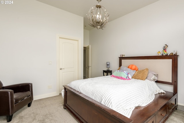 bedroom featuring light colored carpet and an inviting chandelier