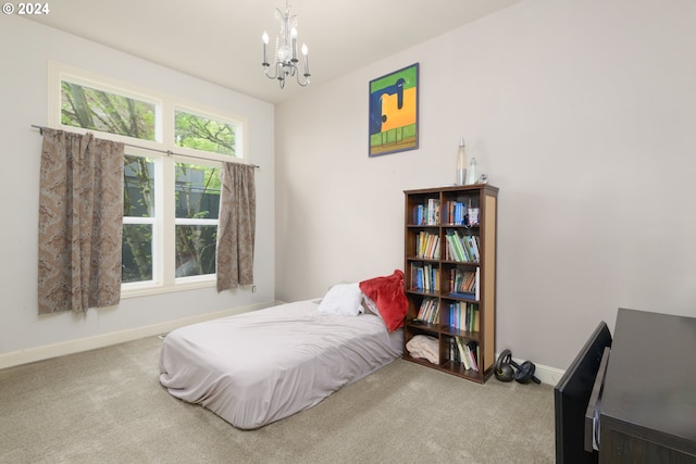 carpeted bedroom with a chandelier