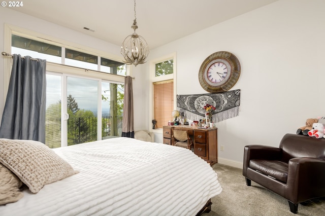 bedroom featuring carpet floors, access to outside, and an inviting chandelier