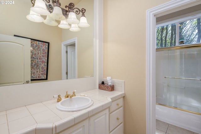 bathroom featuring combined bath / shower with glass door, vanity, and tile floors