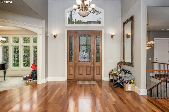 foyer entrance with hardwood / wood-style flooring and a notable chandelier