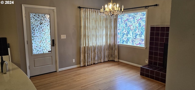 entryway with a notable chandelier and hardwood / wood-style floors