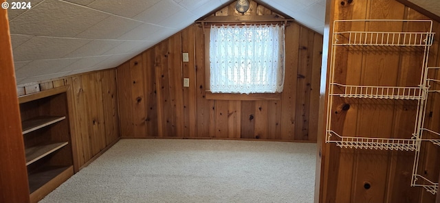 bonus room with carpet, wooden walls, and lofted ceiling