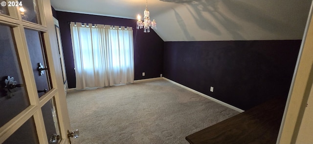 bonus room featuring carpet, an inviting chandelier, and vaulted ceiling