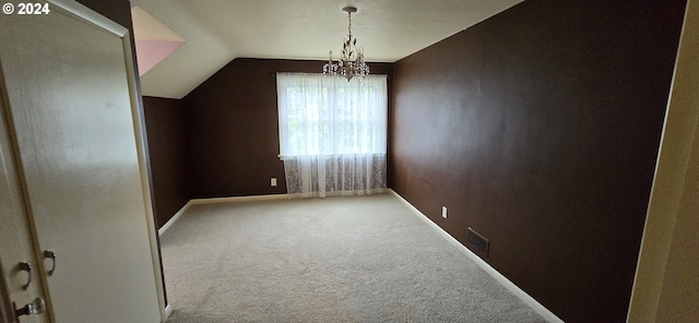 additional living space with carpet, an inviting chandelier, and lofted ceiling