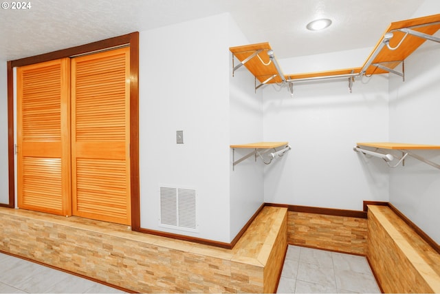 spacious closet with light tile patterned flooring