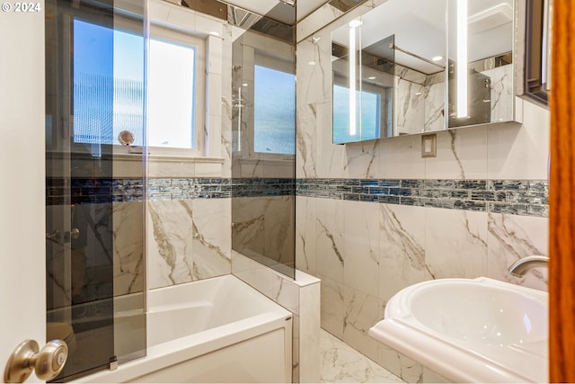 bathroom featuring tile walls, sink, and shower with separate bathtub