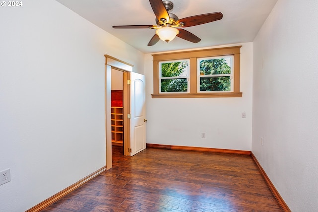 interior space with ceiling fan and dark hardwood / wood-style flooring