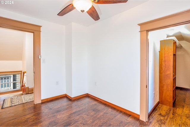 spare room featuring lofted ceiling, dark hardwood / wood-style flooring, and ceiling fan