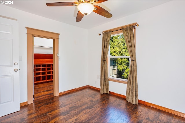 spare room featuring ceiling fan and dark hardwood / wood-style floors