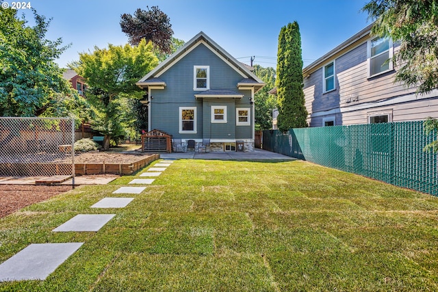 rear view of house featuring a lawn and a patio area