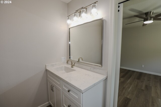 bathroom with ceiling fan, wood-type flooring, and vanity