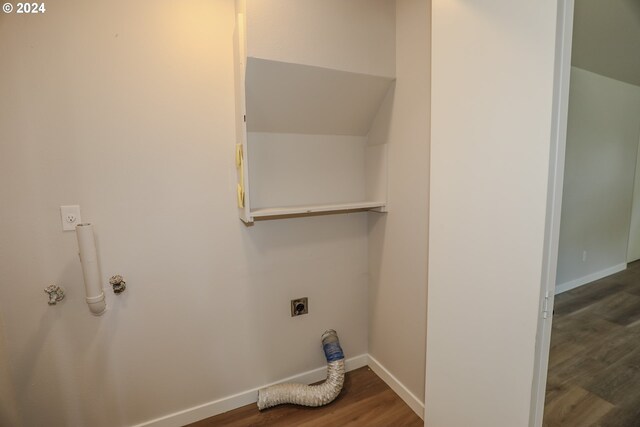 clothes washing area featuring hookup for an electric dryer and dark wood-type flooring