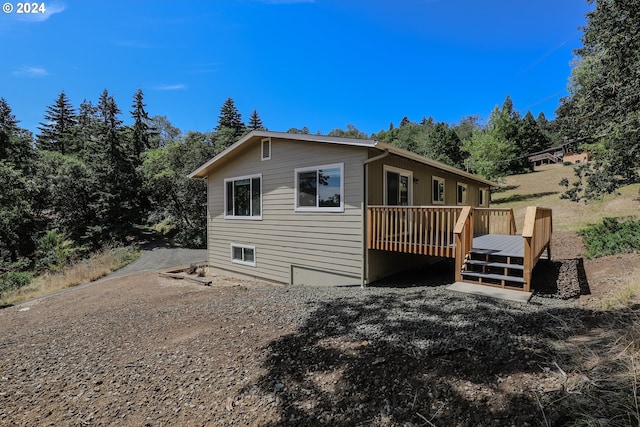 view of side of property featuring a wooden deck