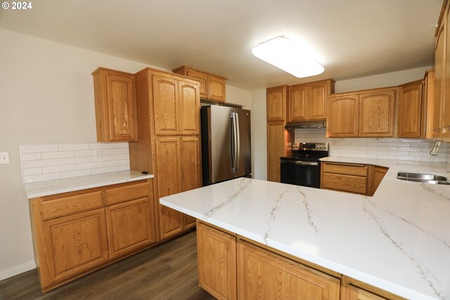 kitchen featuring sink, stainless steel appliances, dark hardwood / wood-style flooring, and tasteful backsplash