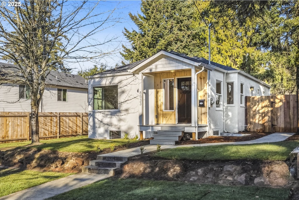 bungalow with a front yard