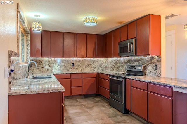 kitchen featuring sink, light tile patterned floors, tasteful backsplash, decorative light fixtures, and stainless steel appliances