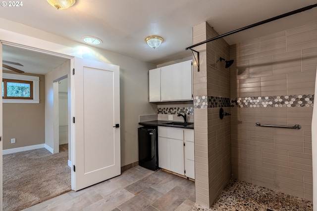 bathroom featuring vanity and tiled shower