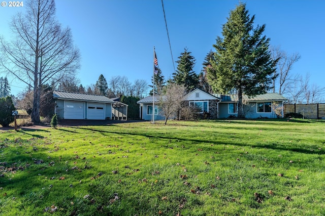 view of yard featuring an outbuilding and a garage