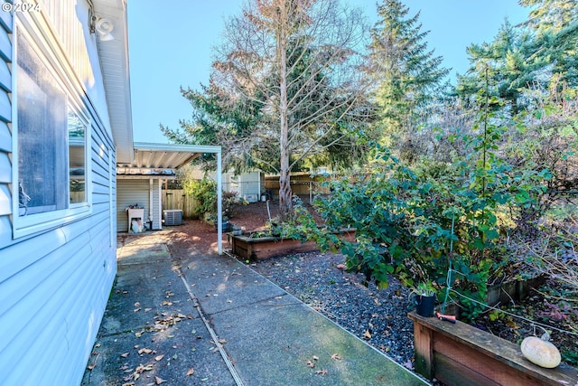 view of yard featuring a patio and central air condition unit