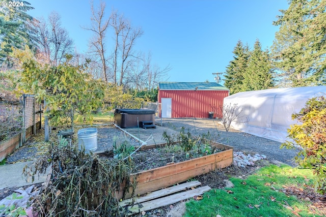 view of yard featuring an outdoor structure and a hot tub