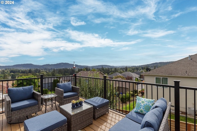 deck with a mountain view and outdoor lounge area