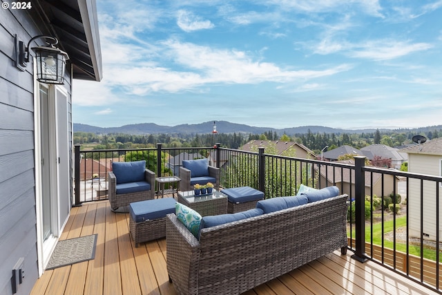 wooden terrace with a mountain view and an outdoor hangout area