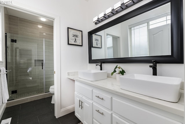 bathroom featuring tile patterned floors, vanity, toilet, and walk in shower