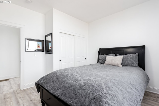 bedroom with a closet and light hardwood / wood-style floors