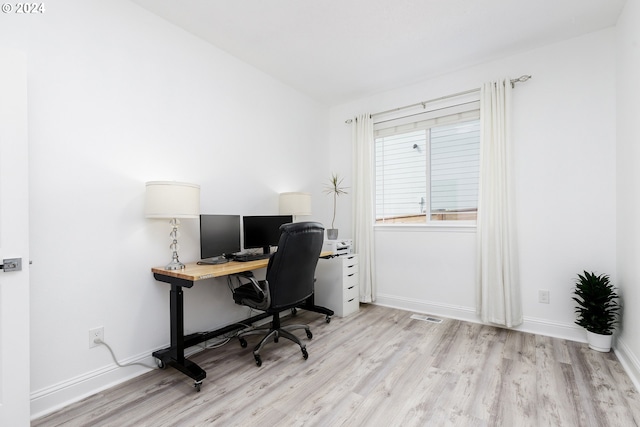 office with light wood-type flooring