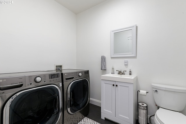 washroom featuring independent washer and dryer and sink