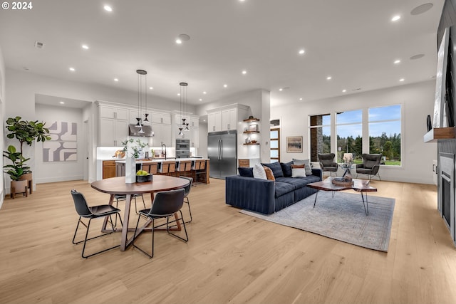 living room featuring sink and light wood-type flooring