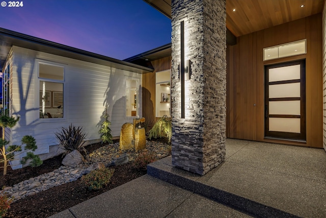 exterior entry at dusk with a patio