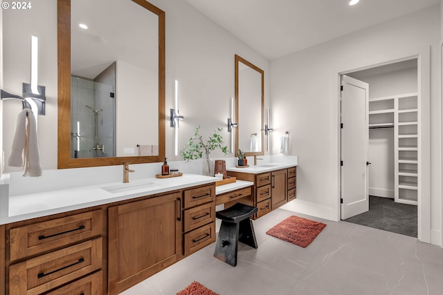 bathroom with tile patterned flooring, vanity, and a shower