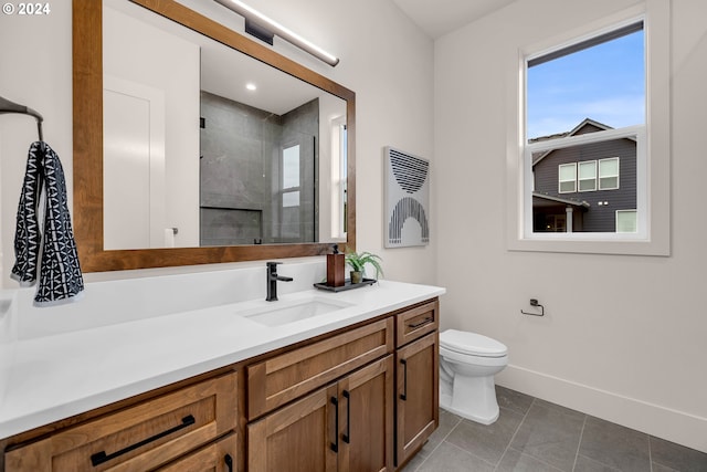 bathroom with tile patterned flooring, vanity, an enclosed shower, and toilet