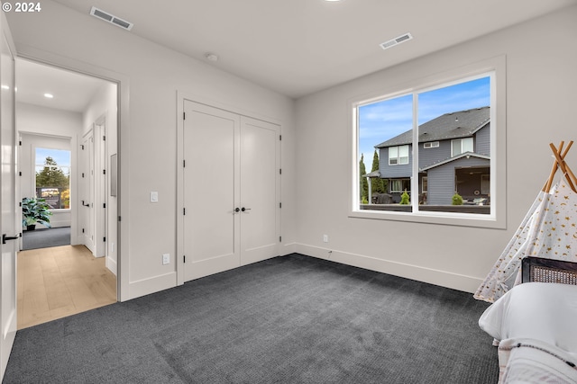 carpeted bedroom with a closet