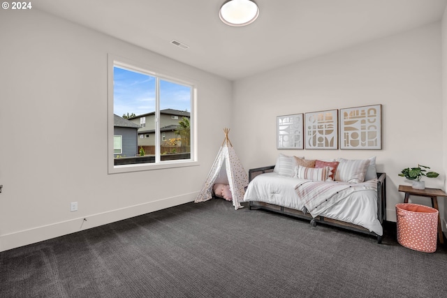 bedroom featuring dark carpet