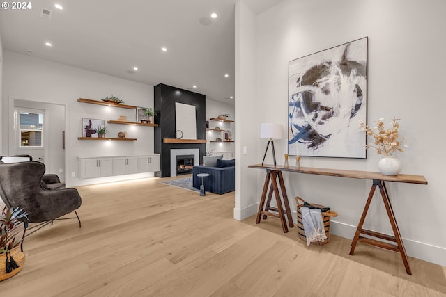 living room with a fireplace and light hardwood / wood-style flooring