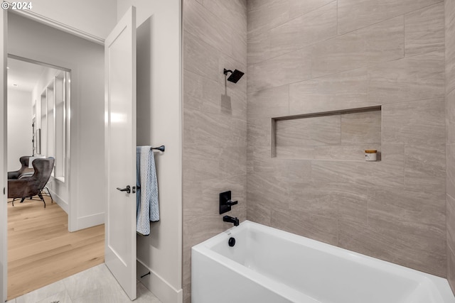 bathroom with wood-type flooring and tiled shower / bath combo