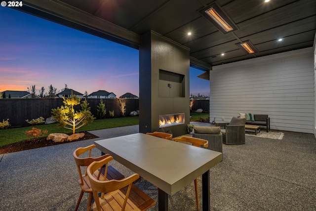 patio terrace at dusk with a large fireplace