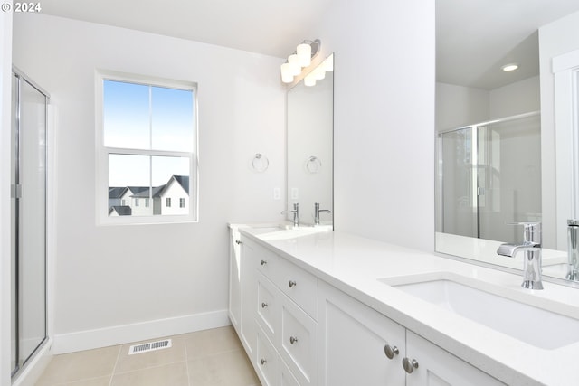 bathroom with vanity, walk in shower, and tile patterned flooring