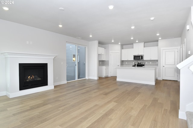 unfurnished living room with light hardwood / wood-style flooring