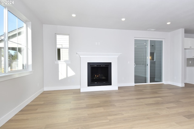 unfurnished living room with light wood-type flooring