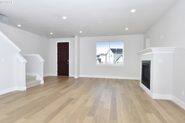 unfurnished living room with light wood-type flooring