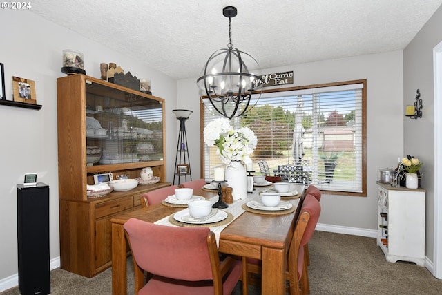 dining room with a notable chandelier, a textured ceiling, and carpet flooring